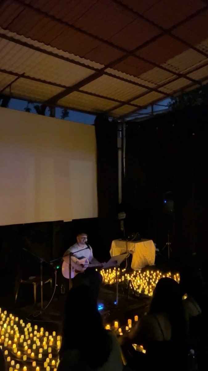 The guitarist mid-set above a sea of candles.