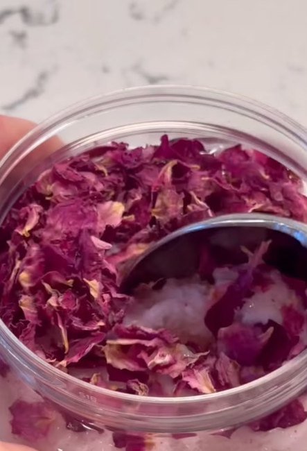 Four open jars of hand-mixed body scrub in different colours.